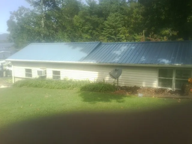 Blue metal roof running the length of a single story home in North